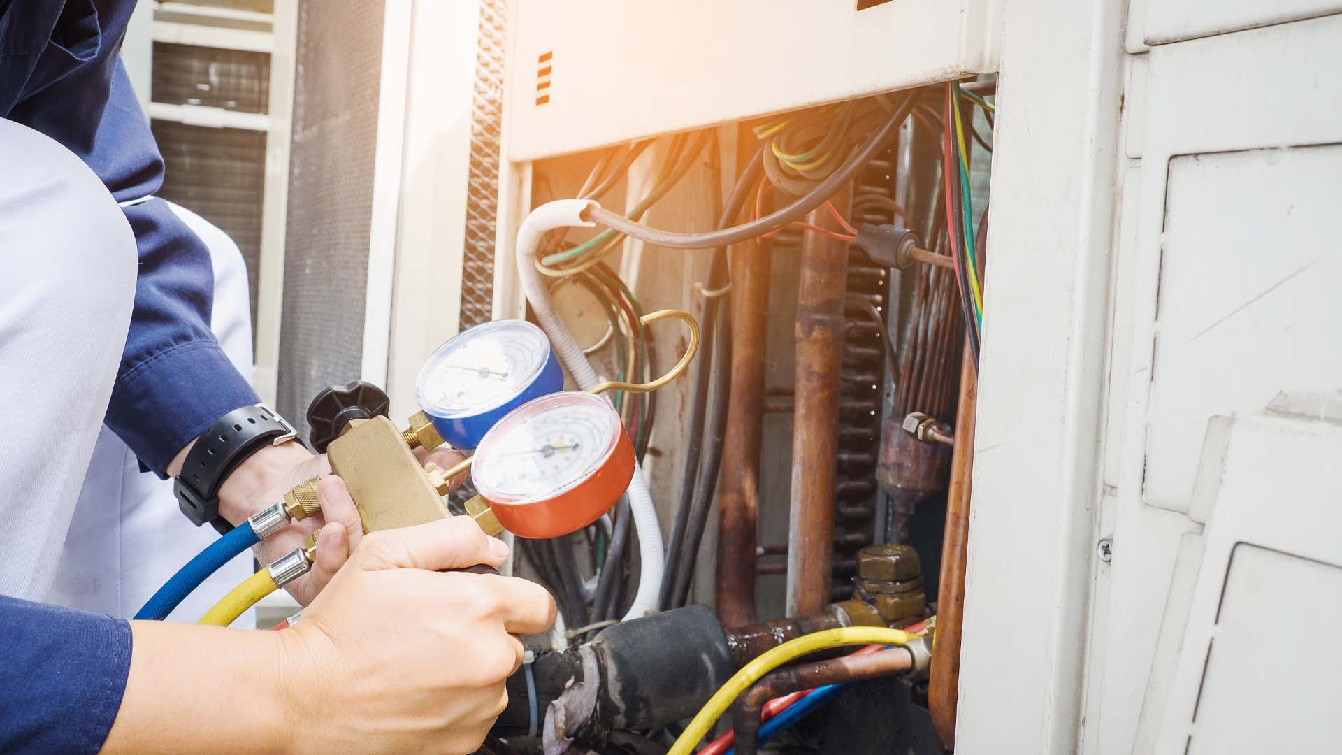 Technician repairing air conditioner appliance. Young man takes care of the cleanliness of the air-conditioning